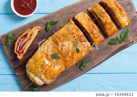 Pizza roll stromboli with cheese salami olives and 58394632