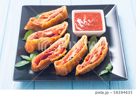 Pizza roll stromboli with cheese salami olives and 58394635