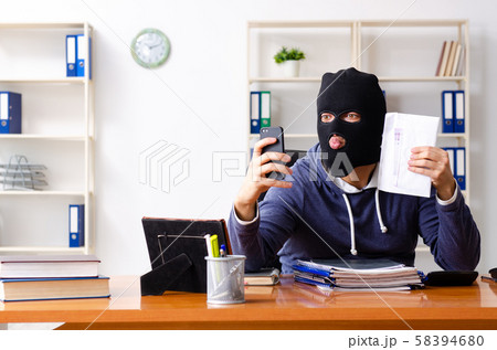 Male thief in balaclava in the office Male thief in balaclava in the office 58394680
