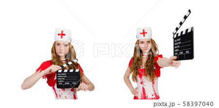 Woman doctor in bloody uniform with movie clapperboard 58397040
