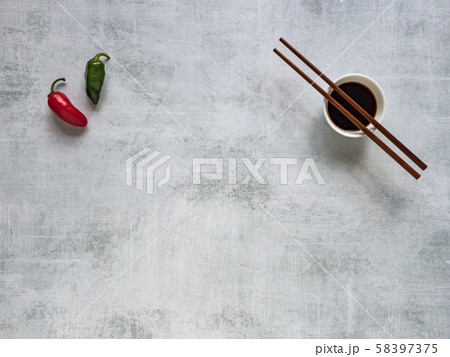 Soy sauce with chopsticks and hot pepper. Top view 58397375