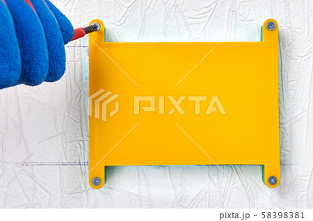 Installing of a plastic junction box in drywall. 58398381