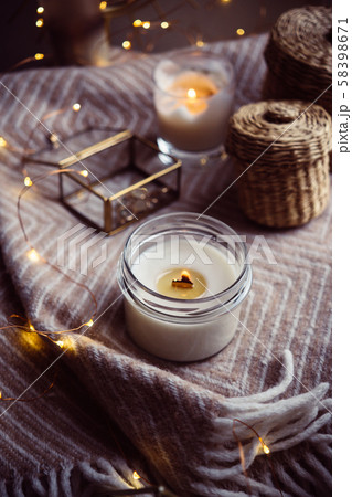 Burning hand-made candle with wooden wick in glass jar Burning hand-made candle with wooden wick in glass jar 58398671
