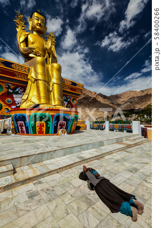 Tibetan Buddhist woman worshiping Buddha, Ladakh 58400266