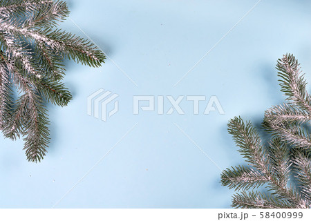 Christmas composition frame made of fir branches on blue background. Christmas, winter concept. Flat 58400999