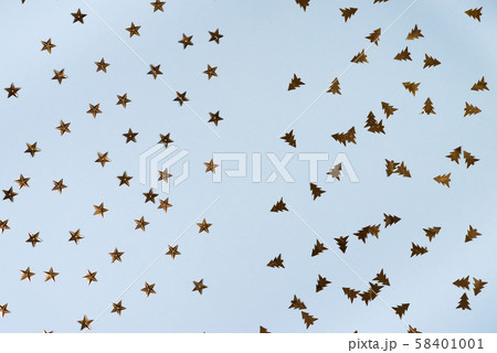 Border made of golden stars and golden trees on blue background. Christmas background. Flat lay. 58401001