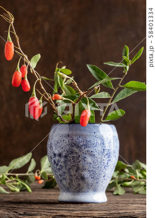 Fresh goji berries in a vase on a table 58401334