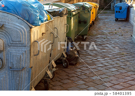 Garbage bins line up on a residential street 58401395
