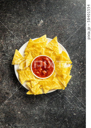 Corn nacho chips and avocado dip. Yellow tortilla Corn nacho chips and avocado dip. Yellow tortilla 58401554