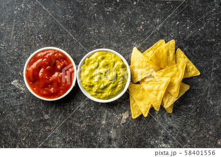 Corn nacho chips and avocado dip. Yellow tortilla Corn nacho chips and avocado dip. Yellow tortilla 58401556