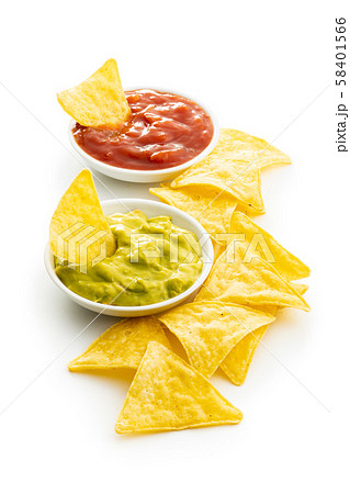 Corn nacho chips with avocado and tomato dip. Corn nacho chips with avocado and tomato dip. 58401566
