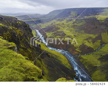 Landscape valley of river Fossa with blue water stream and green hills and moss covered cliffs, in Landscape valley of river Fossa with blue water stream and green hills and moss covered cliffs, in 58402424