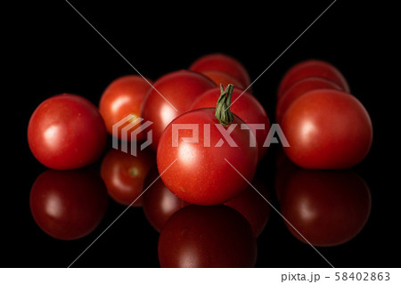 Fresh red tomato isolated on black glass Fresh red tomato isolated on black glass 58402863