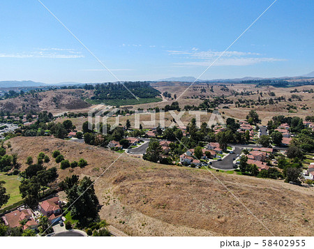 Aerial view of small neighborhood with dry desert mountain on the background in Moorpark Aerial view of small neighborhood with dry desert mountain on the background in Moorpark 58402955