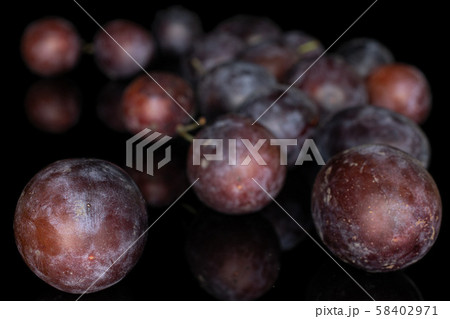 Sweet purple plum isolated on black glass Sweet purple plum isolated on black glass 58402971