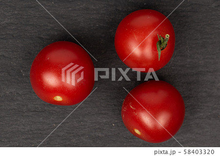 Fresh red tomato on grey stone 58403320