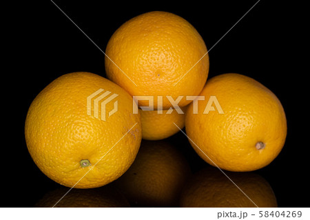 Fresh bright orange isolated on black glass Fresh bright orange isolated on black glass 58404269