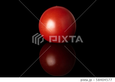 Fresh red tomato isolated on black glass Fresh red tomato isolated on black glass 58404577