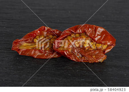 Dry red cherry tomato on grey stone Dry red cherry tomato on grey stone 58404923