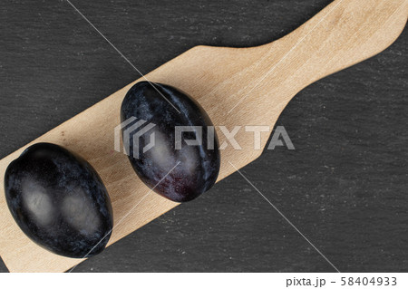 Fresh purple plum on grey stone 58404933