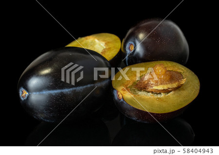 Fresh purple plum isolated on black glass Fresh purple plum isolated on black glass 58404943