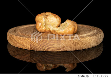 Golden baked profiterole isolated on black glass 58404955