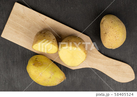 Raw brown potato on grey stone 58405524