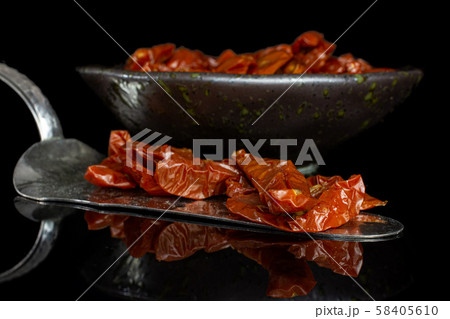Dry red cherry tomato isolated on black glass 58405610