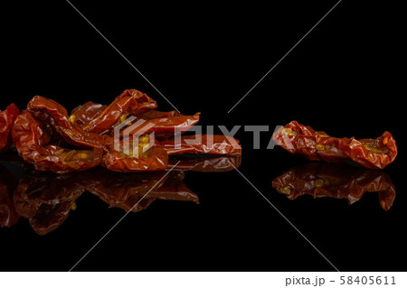 Dry red cherry tomato isolated on black glass Dry red cherry tomato isolated on black glass 58405611