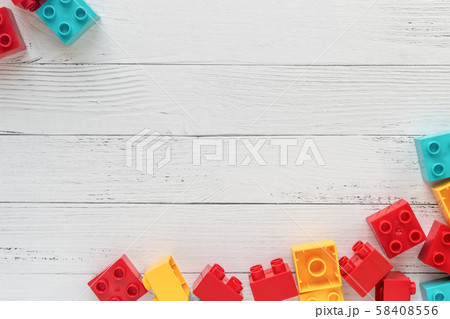 Plastic constructor bricks on white wooden Plastic constructor bricks on white wooden 58408556