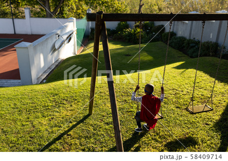 Superhero boy in garden Superhero boy in garden 58409714