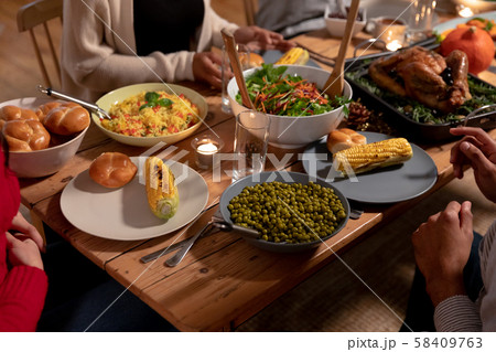 Millennial adult friends celebrating Thanksgiving together at home Millennial adult friends celebrating Thanksgiving together at home 58409763