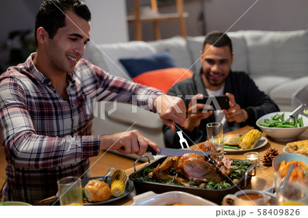 Millennial adult friends celebrating Thanksgiving together at home Millennial adult friends celebrating Thanksgiving together at home 58409826