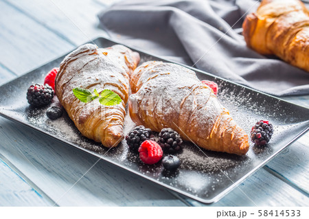 Freshly crispy croissants sprinkled sugar powder Freshly crispy croissants sprinkled sugar powder 58414533