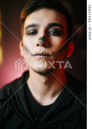 Young man with Halloween make-up looks at the camera 58414992