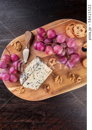 Gorgonzola cheese, shot from the top on a dark rustic wooden background with a place for text Gorgonzola cheese, shot from the top on a dark rustic wooden background with a place for text 58415522