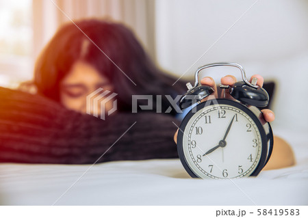 Sleepy lazy Asian teen girl still in bed wake up Sleepy lazy Asian teen girl still in bed wake up 58419583