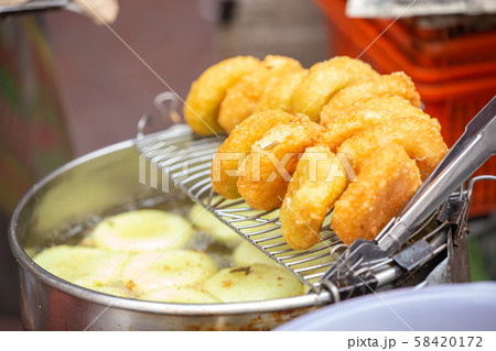 Chinese style deep fried dough buns in hot oil Chinese style deep fried dough buns in hot oil 58420172