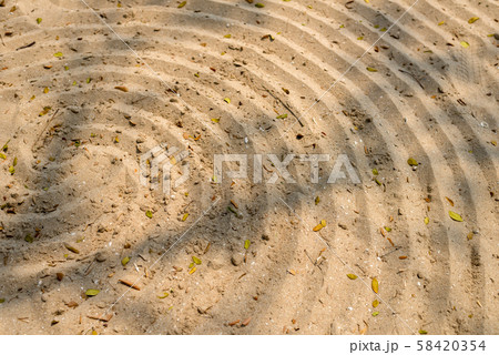 Spiral pattern design in sand on the beach 58420354