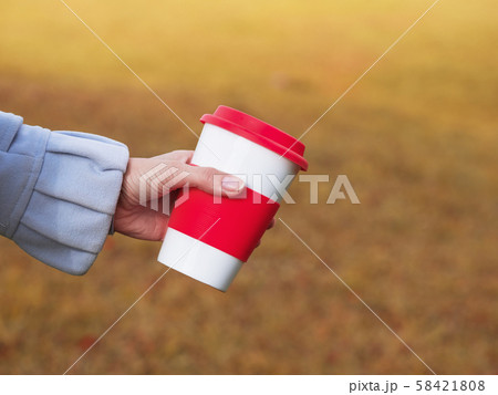 Reusable coffee cup in the hands on the nature 58421808