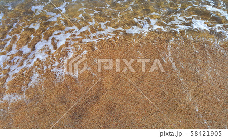 Clear sea water in the coastal sand 58421905