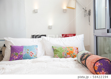 bed with colorful pillows - cozy bedroom bed with colorful pillows - cozy bedroom 58422194