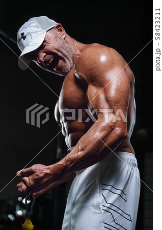 Handsome strong athletic men pumping up biceps Handsome strong athletic men pumping up biceps 58423211