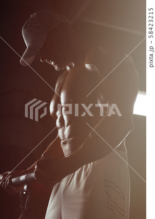 Handsome strong athletic men pumping up biceps Handsome strong athletic men pumping up biceps 58423215