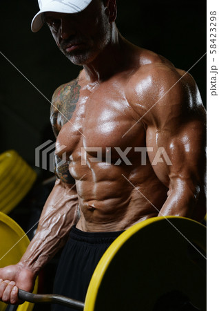 Handsome strong athletic men pumping up biceps 58423298