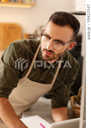 Dark-eyed owner of coffee shop feeling thoughtful Dark-eyed owner of coffee shop feeling thoughtful 58425547