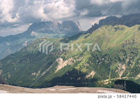 Idyllic Alps with green hill under cloud sky 58427440