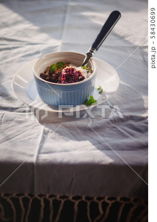 baked oat-blueberry crumble with mint in a white 58430699
