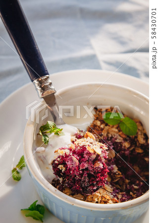 baked oat-blueberry crumble with mint in a white 58430701