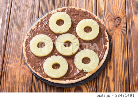 Fruit pizza with nut nougat cream and pineapple 58431491